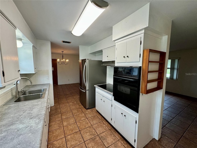 kitchen featuring black appliances, white cabinets, and sink