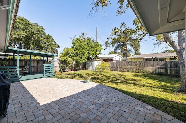 view of patio with a storage shed