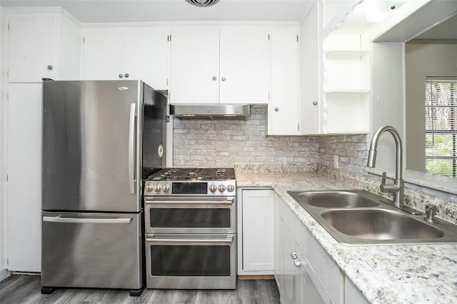 kitchen with ventilation hood, stainless steel appliances, decorative backsplash, white cabinets, and sink