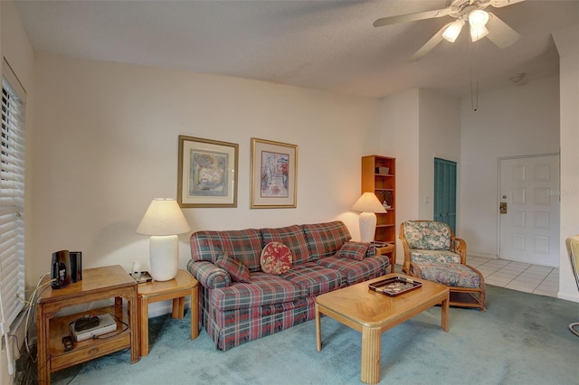 carpeted living room featuring a high ceiling, a textured ceiling, and ceiling fan