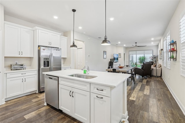 kitchen featuring white cabinetry, ceiling fan, sink, stainless steel appliances, and pendant lighting