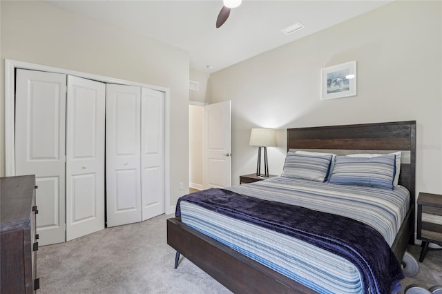 carpeted bedroom with ceiling fan and a closet