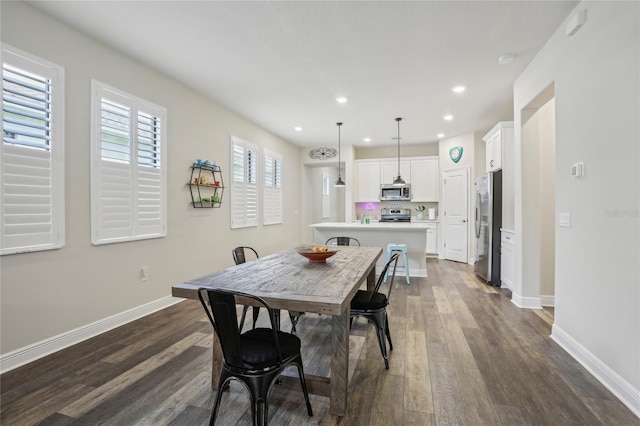 dining space featuring recessed lighting, dark wood finished floors, and baseboards