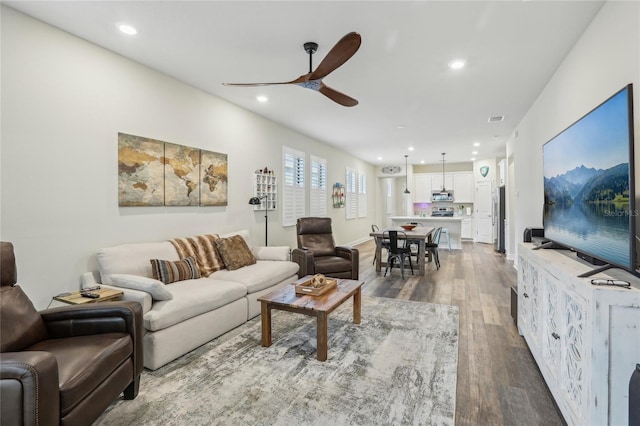 living room featuring recessed lighting, visible vents, ceiling fan, and wood finished floors