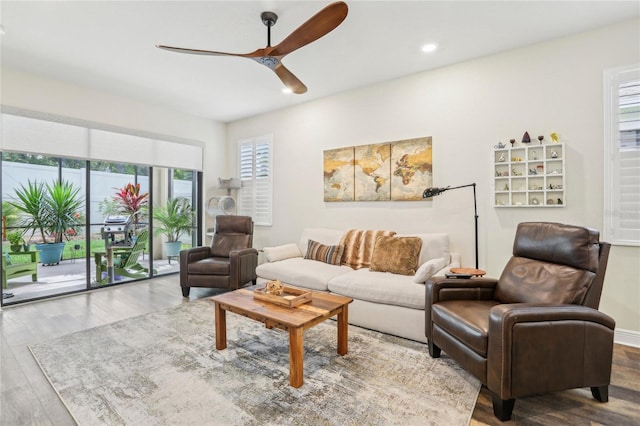 living room featuring a ceiling fan, recessed lighting, and wood finished floors