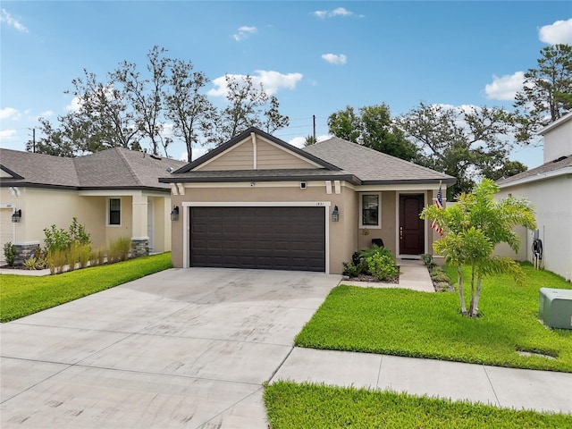 single story home featuring a garage, a shingled roof, concrete driveway, stucco siding, and a front lawn