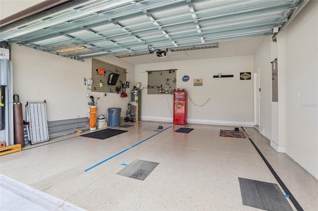 garage with water heater, electric panel, and a garage door opener