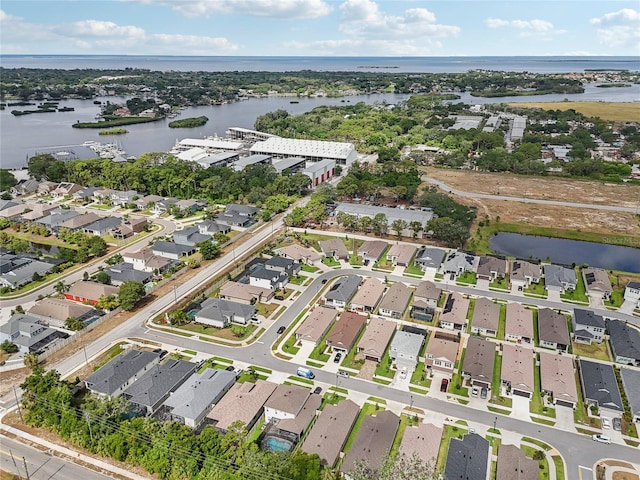 birds eye view of property featuring a water view and a residential view