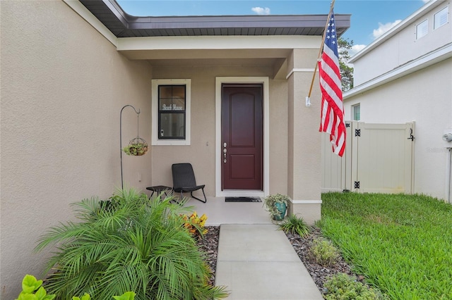 view of exterior entry with stucco siding