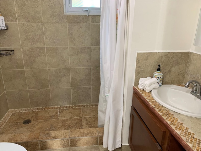 bathroom featuring toilet, vanity, and a shower with shower curtain