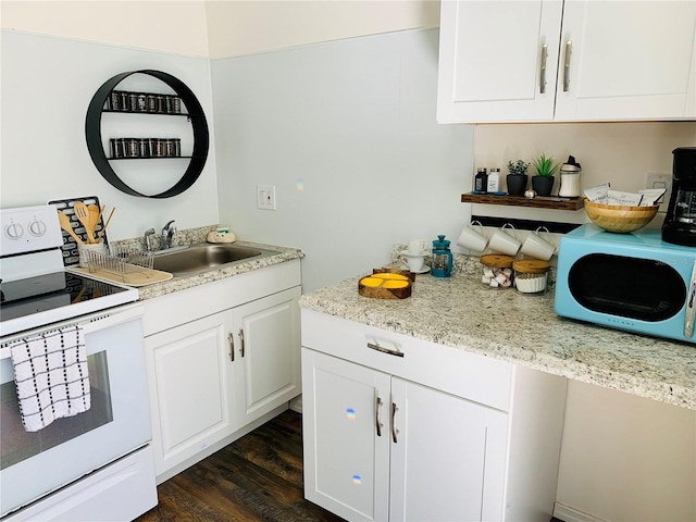 kitchen with white cabinetry, sink, light stone counters, dark hardwood / wood-style floors, and white appliances