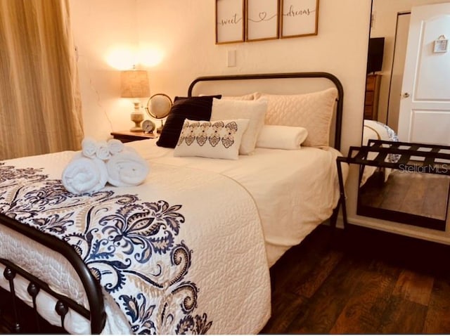 bedroom featuring dark hardwood / wood-style flooring