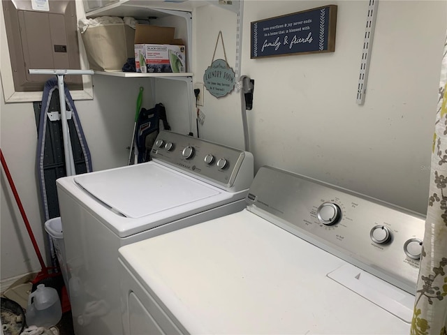 laundry area with washing machine and dryer and electric panel