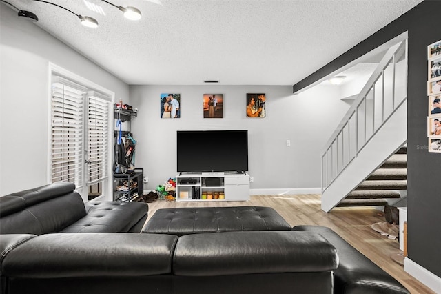 living room with light hardwood / wood-style flooring and a textured ceiling