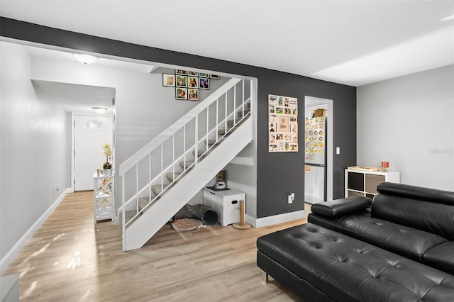 living room featuring a textured ceiling and hardwood / wood-style flooring