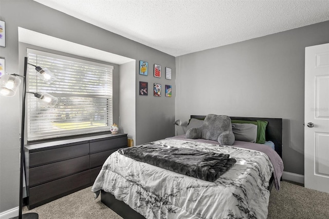 bedroom with carpet, a textured ceiling, and multiple windows