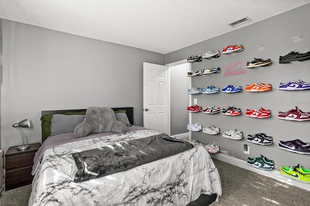 carpeted bedroom featuring a textured ceiling