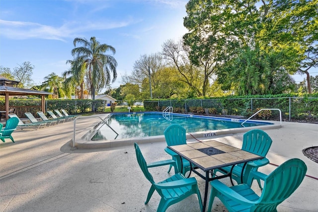 view of swimming pool with a patio