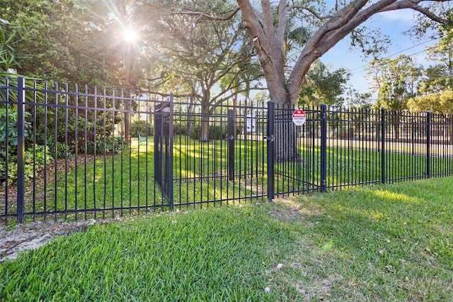 view of gate featuring a lawn