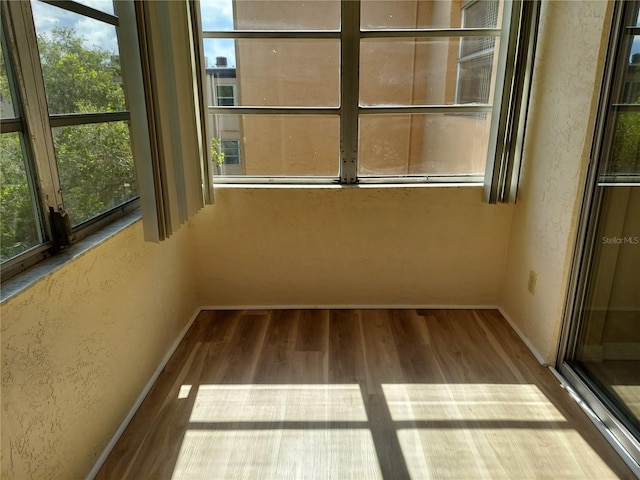 unfurnished sunroom featuring plenty of natural light