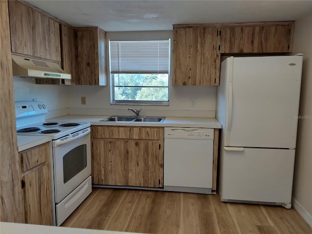 kitchen with sink, white appliances, light hardwood / wood-style flooring, and custom exhaust hood