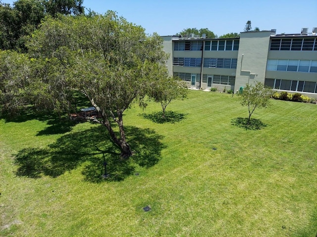 view of home's community with a lawn