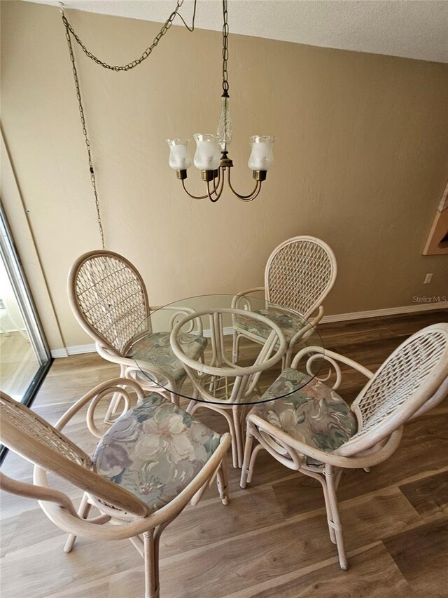 interior space with a chandelier, a textured ceiling, and hardwood / wood-style flooring