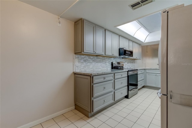 kitchen with decorative backsplash, gray cabinets, stainless steel electric range oven, light tile patterned floors, and light stone counters