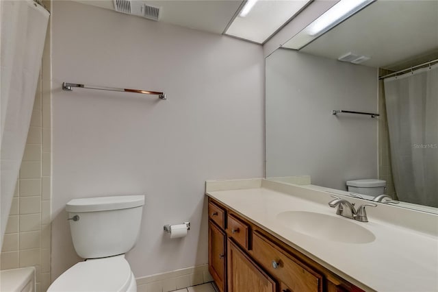 bathroom with tile patterned flooring, vanity, a shower with shower curtain, and toilet