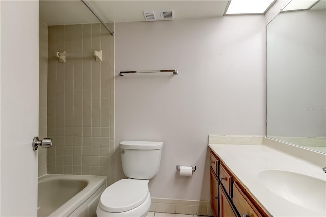 full bathroom featuring tile patterned flooring, vanity, tiled shower / bath combo, and toilet