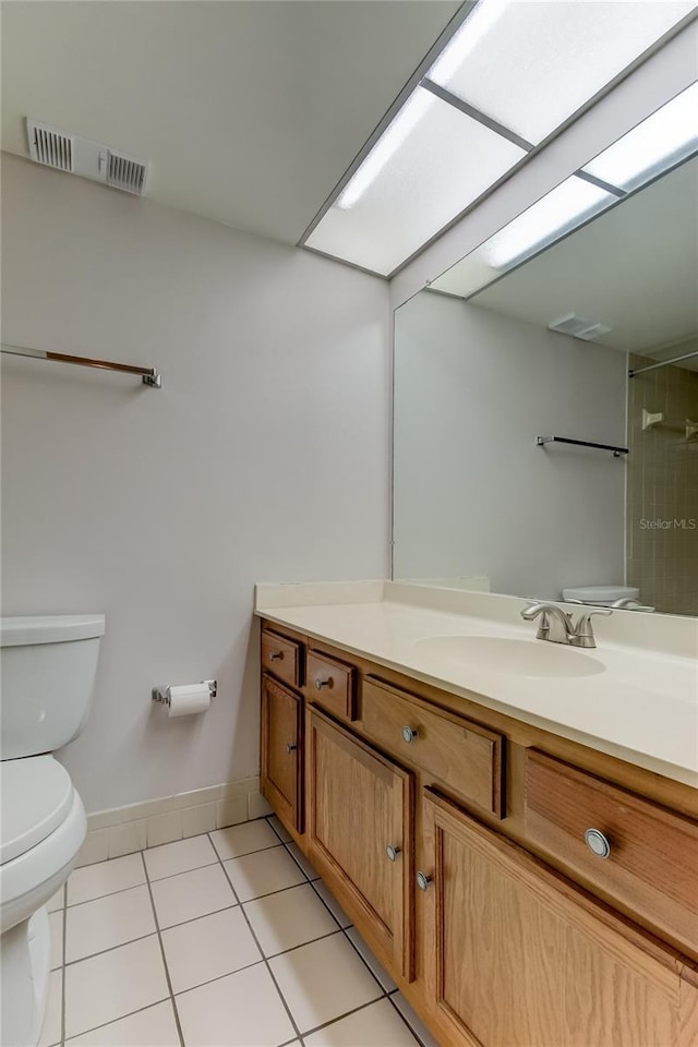 bathroom with tile patterned floors, vanity, and toilet