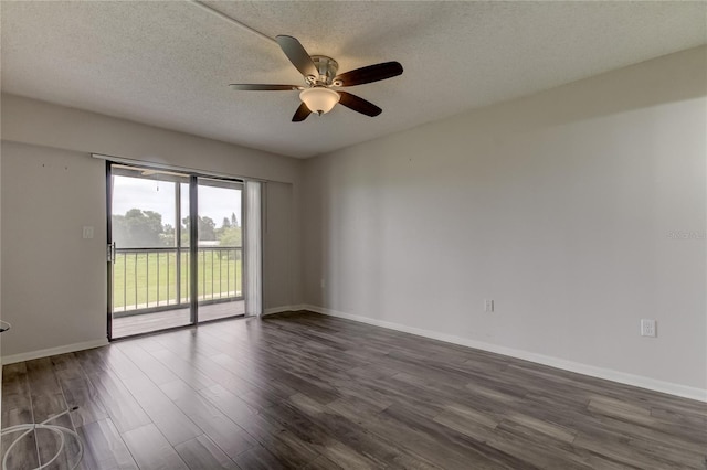 spare room with ceiling fan, a textured ceiling, and dark wood-type flooring