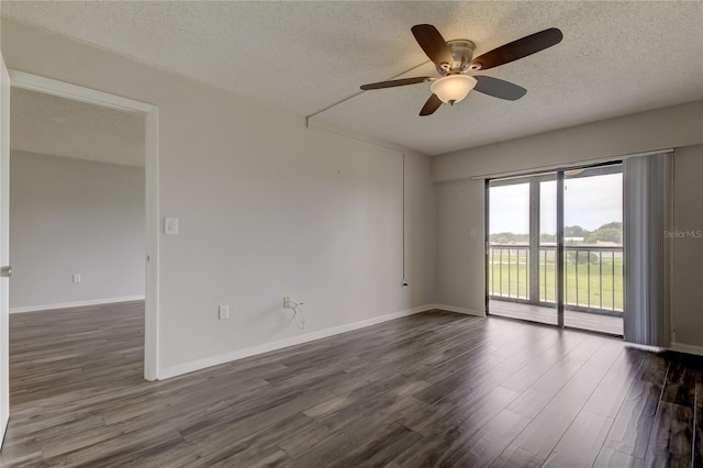 unfurnished room with ceiling fan, dark wood-type flooring, and a textured ceiling