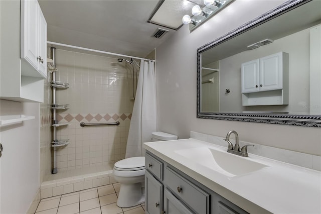 bathroom with tile patterned floors, toilet, vanity, and a shower with shower curtain