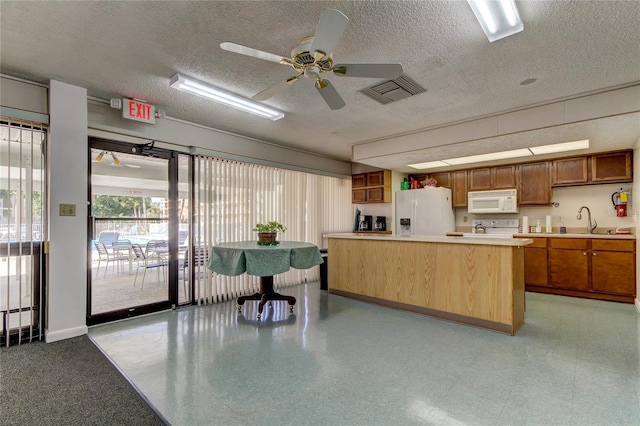 kitchen with ceiling fan, sink, a textured ceiling, white appliances, and a kitchen island