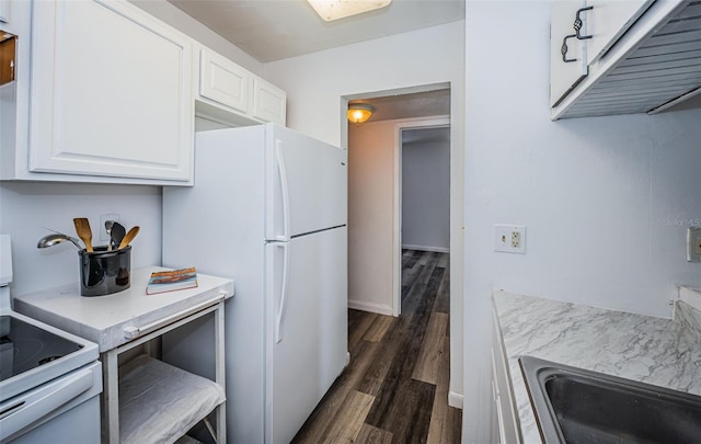 kitchen with dark wood-type flooring, white appliances, sink, and white cabinets