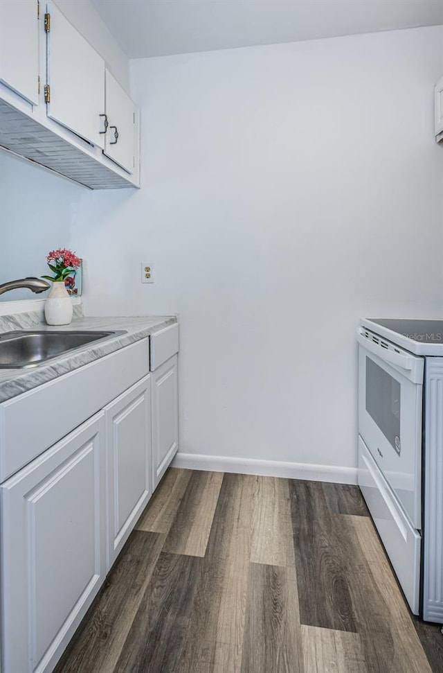 kitchen with dark wood-type flooring, sink, white cabinetry, and white range oven