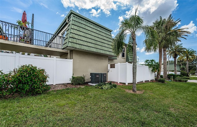 view of property exterior featuring a yard and central air condition unit