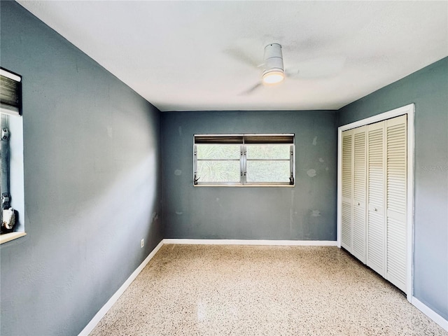 unfurnished bedroom featuring a closet and ceiling fan