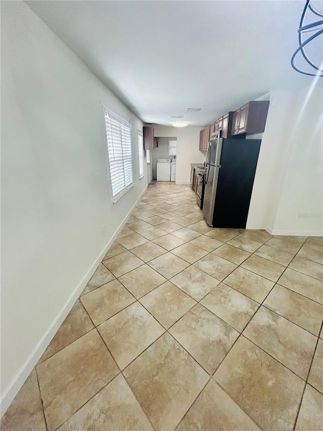 kitchen with stainless steel fridge and light tile patterned floors