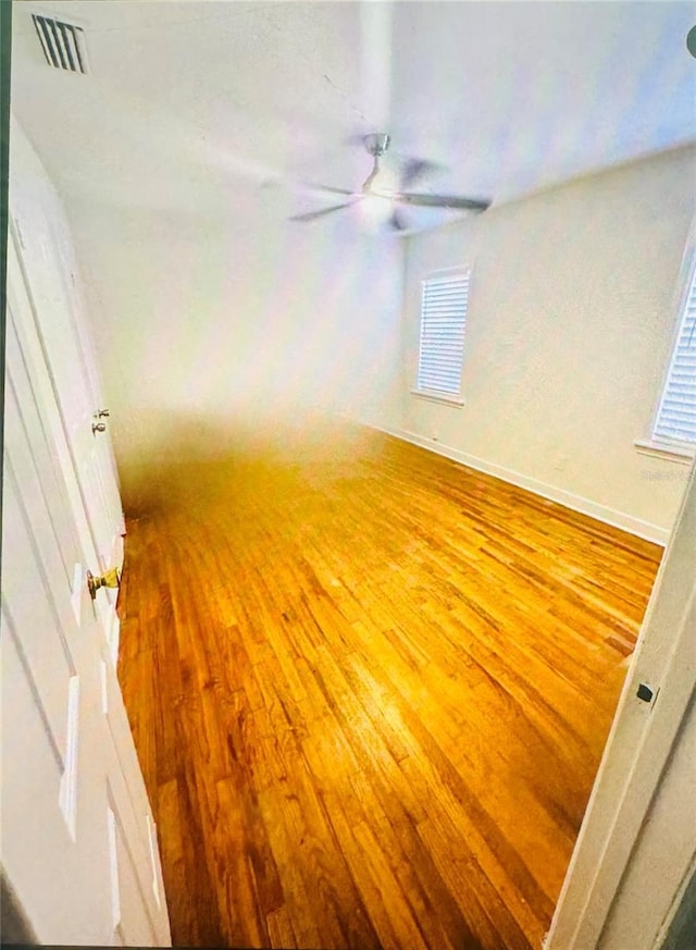 empty room featuring ceiling fan and light wood-type flooring