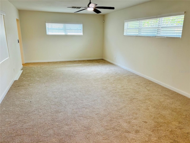 carpeted empty room featuring ceiling fan