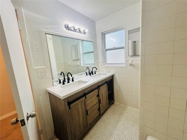 bathroom featuring tile patterned flooring, vanity, and tile walls