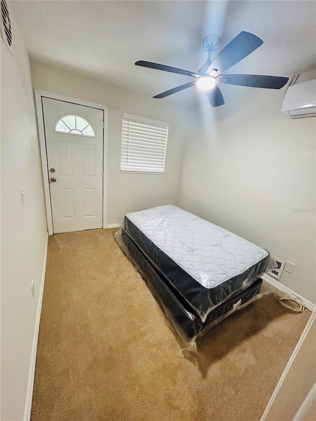 bedroom with ceiling fan, an AC wall unit, and light carpet