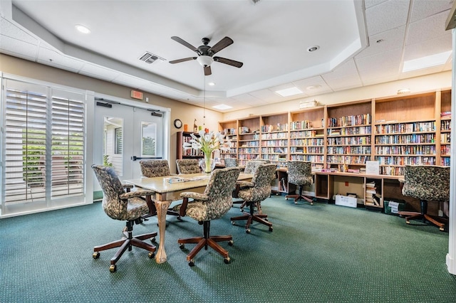 carpeted dining area featuring a tray ceiling