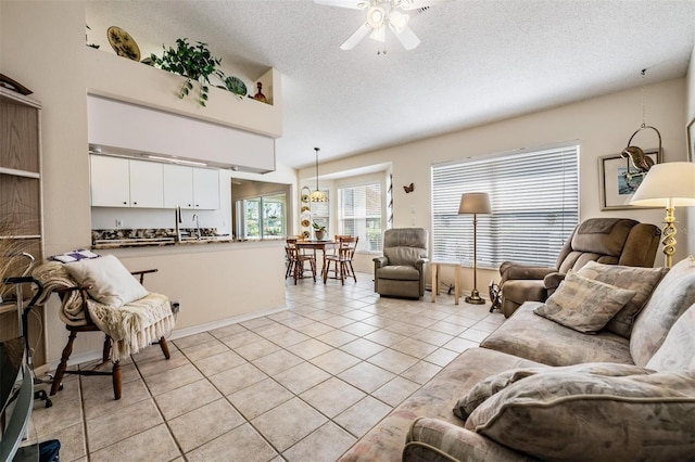 tiled living room featuring a textured ceiling and ceiling fan