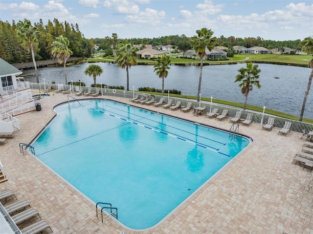 view of pool with a patio area and a water view