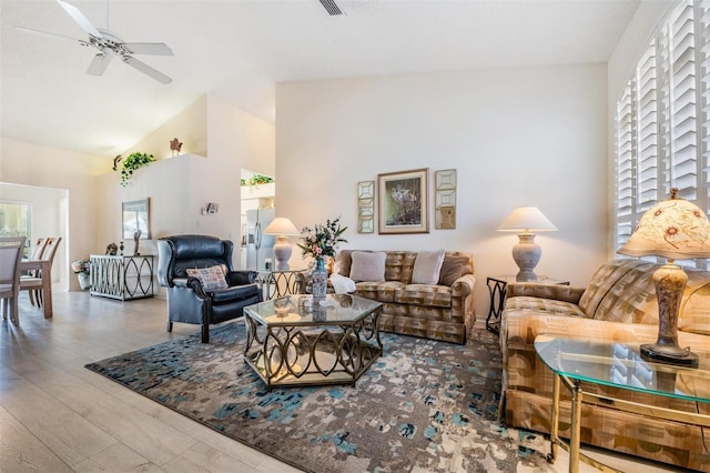 living room with hardwood / wood-style flooring, lofted ceiling, and ceiling fan