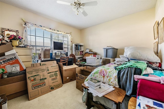 carpeted bedroom with ceiling fan and a textured ceiling