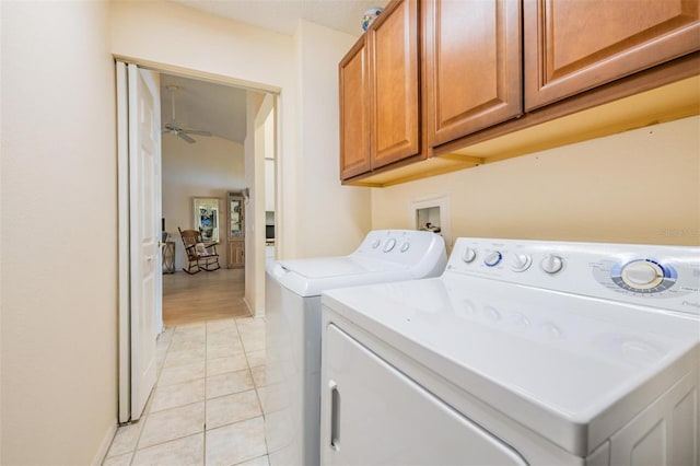 washroom featuring ceiling fan, washer and clothes dryer, light tile patterned floors, and cabinets